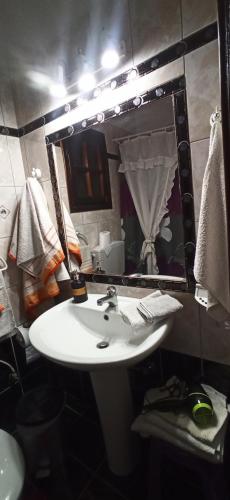 a bathroom with a white sink and a mirror at Villa Maria in Kalymnos
