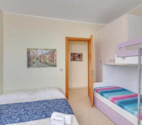 a bedroom with two beds and a bunk bed at L'orchidea appartamento in Puglia in Sammichele di Bari