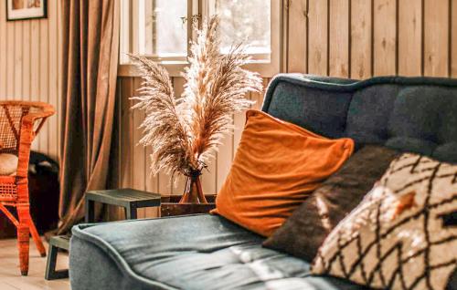 a blue couch with an orange pillow in a living room at Awesome Home In Askome With Wifi in Askome