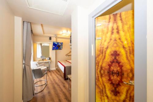 a room with a door leading to a room with a bed at Ramada By Wyndham Istanbul Pera Taksim in Istanbul