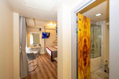 a room with a bedroom with a bed and a sliding door at Ramada By Wyndham Istanbul Pera Taksim in Istanbul