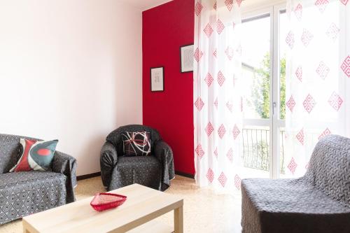 a living room with two chairs and a window at La Ginestra - between lake and mountains in Colazza