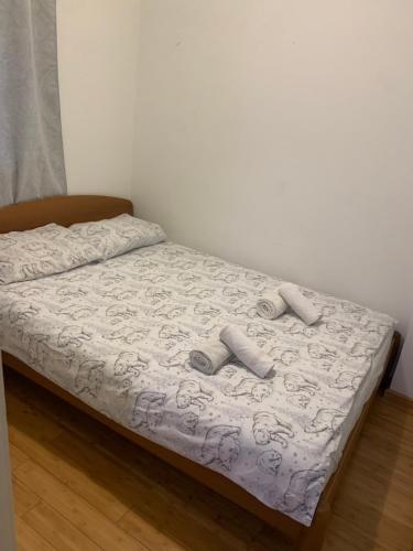 a bed with two pairs of slippers on it at Apartment Rose II in Zagreb