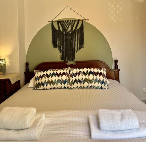 a bedroom with a bed with two towels on it at Villa Merci Budva in Budva