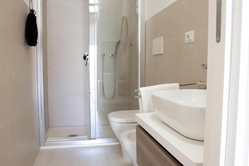 a bathroom with a shower and a toilet and a sink at Guest House Sciola - TS ROOMS B&B in San Sperate