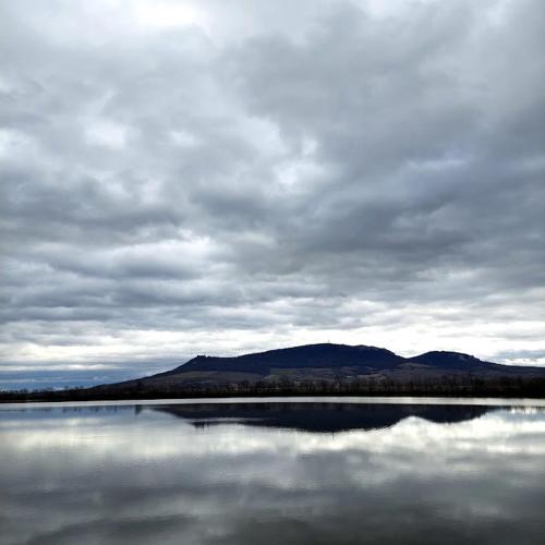 a large body of water with mountains in the background at Penzion Hazdrovi in Strachotín