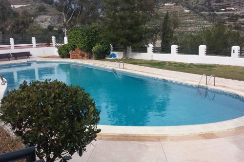 a large blue swimming pool in a yard at Blue Horizon Apartment in Granada