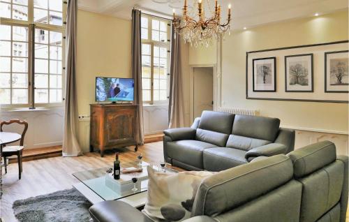a living room with a couch and a tv at La Labrousse in Sarlat-la-Canéda