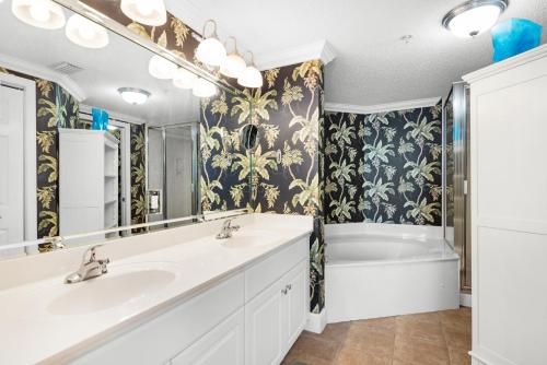 a bathroom with two sinks and a tub at Majestic Beach Towers 1-1701 in Panama City Beach