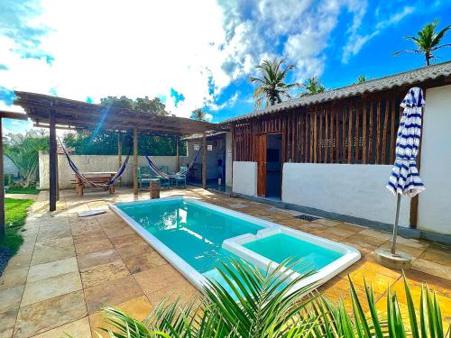 a swimming pool in the backyard of a house at Casa Branca BG in Barra Grande