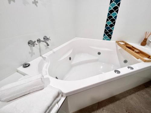 a white bath tub in a white bathroom at Ocean View 2BR Apartment and SPA in Gold Coast