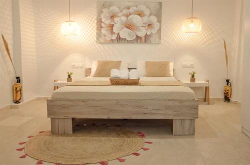 a bedroom with a large bed and a rug at Vel Boutique Suites in Agia Galini