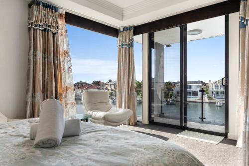 a bedroom with a bed and a large window at stunning prestige residence in Gold Coast