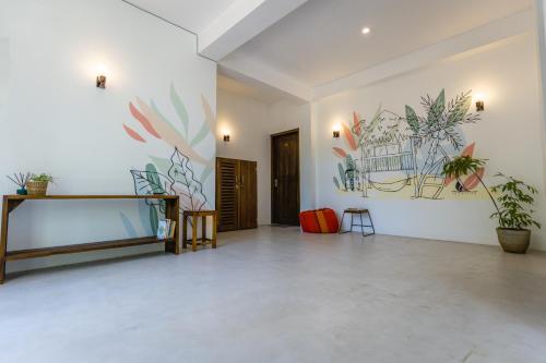 a large room with plants on the walls at Atrium Hiriketiya in Hiriketiya