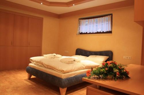 a bedroom with a bed with two dogs on it at Wald-Hotel Heppe in Dammbach