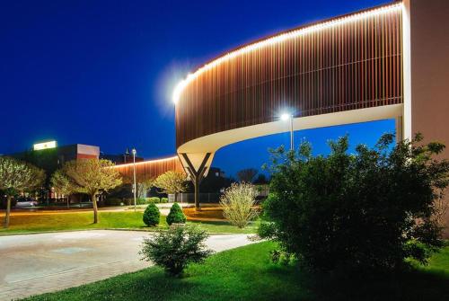 a building with a lit up facade at night at Apartma Rakita in Moravske Toplice