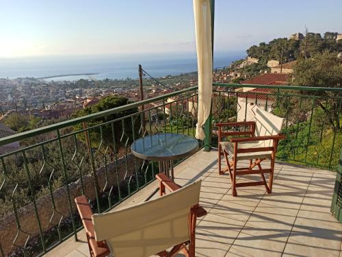 a balcony with a table and chairs and a view at Kiparissia Castle & Sea view in Kyparissia