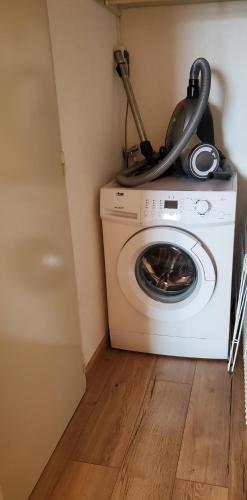 a washing machine with a pot on top of it at Bel appartement spacieux 44m² à SUPER BESSE pour 6 personnes in Super Besse