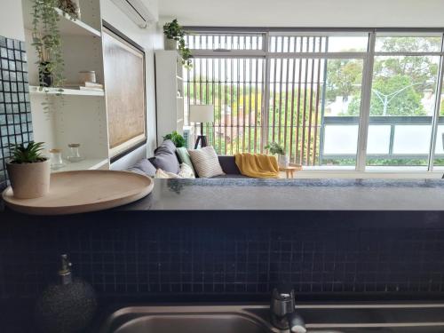 a kitchen with a sink and a large window at Sunset Beach Paradise St Kilda in Melbourne