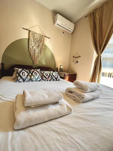 a bedroom with a bed with towels on it at Villa Merci Budva in Budva