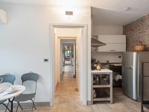 a kitchen and dining room with a table and chairs at Stagno Lombardo Garden Flat in Stagno Lombardo