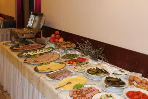a table with many plates of food on it at Hotel Relaks in Wola Ducka