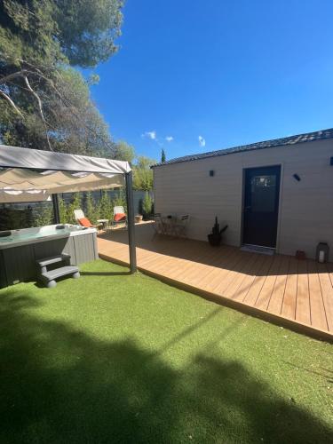 a backyard with a wooden deck and a building at Suite La Farigoulette in Marseille