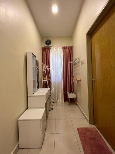 a hallway of a room with a tv and a window at Entire Vacation Home with landscape garden in Sitiawan