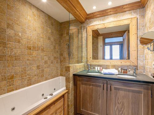 a bathroom with two sinks and a mirror and a tub at Appartement Val-d'Isère, 5 pièces, 8 personnes - FR-1-694-114 in Val-d'Isère