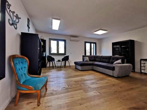 ein Wohnzimmer mit einem Sofa und einem Stuhl in der Unterkunft Casa da Maria, Montegrazie (IM) in Montegrazie