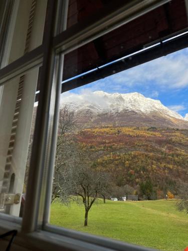 a view of a snow covered mountain from a window at Apartments Mala Korita Soče in Soča