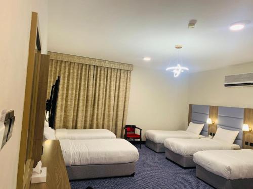 מיטה או מיטות בחדר ב-Silver Sand Hotel