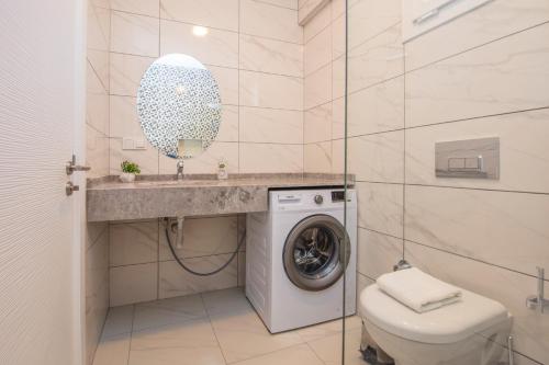 a bathroom with a washing machine and a sink at SunTeos Villa Suites in Fethiye