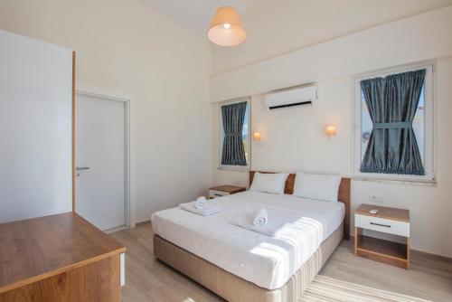 a bedroom with a large white bed in a room at SunTeos Villa Suites in Fethiye