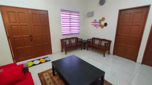 a living room with a table and two chairs at Che Det Homestay Chemor in Chemor