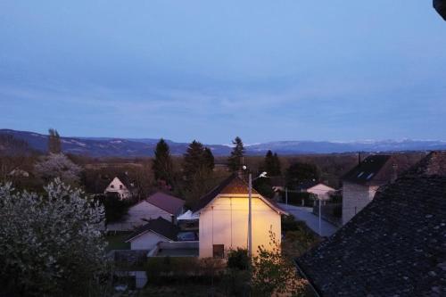 a view of a town with a lit up building at Ecrin de bien-être au pays des couleurs in Saint-Victor-de-Morestel