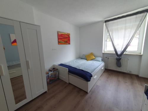 a small bedroom with a bed and a window at Brunnalm Ski - Ferien Apartment - Veitsch - max 6 Person in Niederaigen