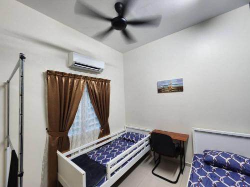 a bedroom with a bed and a ceiling fan at D'Kampung Homestay Melaka in Melaka