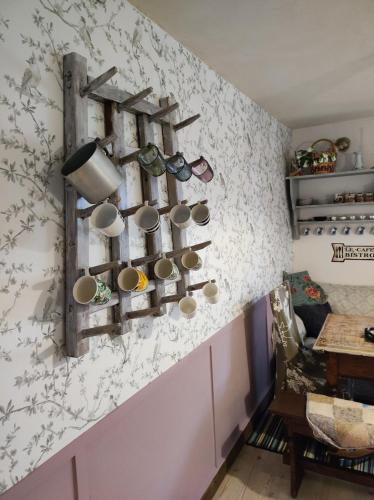 a room with a wall with cups and utensils at Violeta in Dambach