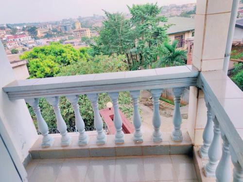 a white balcony with a view of a city at Bel Appartement meublé à Bastos in Yaoundé