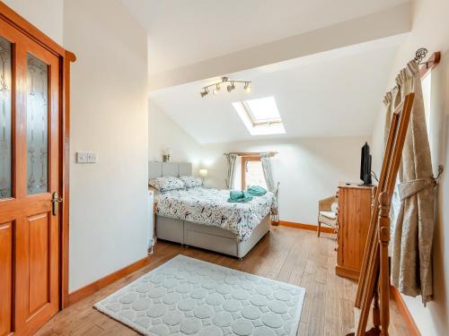 a small bedroom with a bed and a window at The Old Dairy in Clay Cross