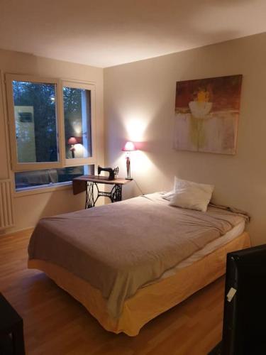 - une chambre avec un lit avec une lampe et 2 fenêtres dans l'établissement Appartement 2 chambres Anglet, proche Biarritz, à Anglet