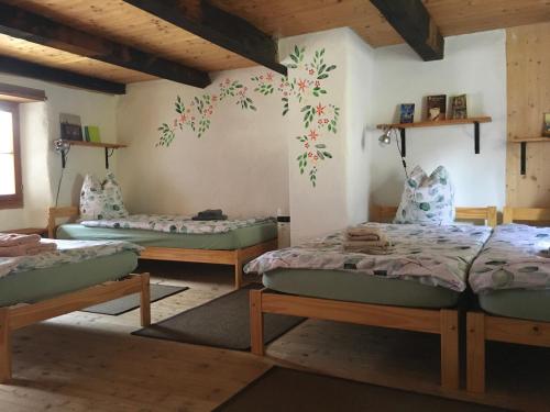 a room with three beds in a room at Centro Arte Cabbiolo in Cabbiolo