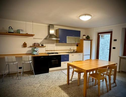 a kitchen with a wooden table and a table and chairs at Maison Dédé - CIR Charvensod 0004 in Charvensod