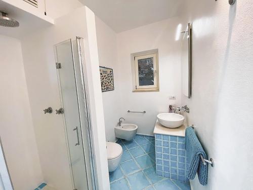 a bathroom with a toilet and a sink at VIP View & Exclusive Access to the Sea in Porto Santo Stefano