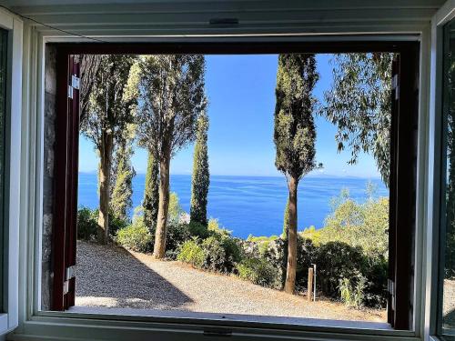 a window view of the ocean from a house at VIP View & Exclusive Access to the Sea in Porto Santo Stefano