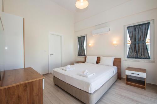 a bedroom with a large bed and a television at SunTeos Villa Suites in Fethiye