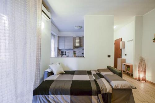 a bedroom with a bed and a large window at [20min. Duomo] Design, Wi-fi. in Sesto San Giovanni