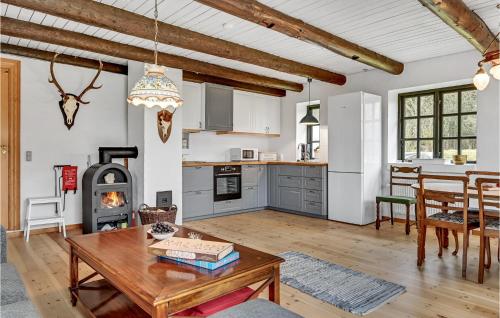 a kitchen and living room with a table and a stove at Lovely Apartment In Glesborg With Wifi in Glesborg