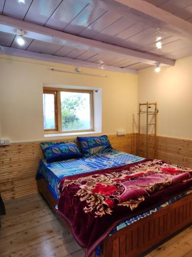 a large bed in a room with a window at Neo Heaven's Stays BIR in Baijnāth